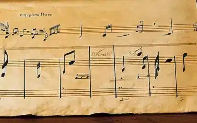 Una hoja desgastada de música reposa sobre una mesa de madera con un antiguo y hermoso lyre en el encabezado